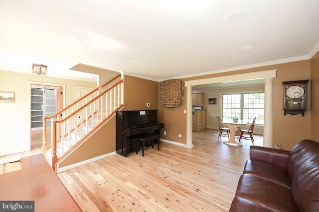 living room with ornamental molding and light hardwood / wood-style flooring