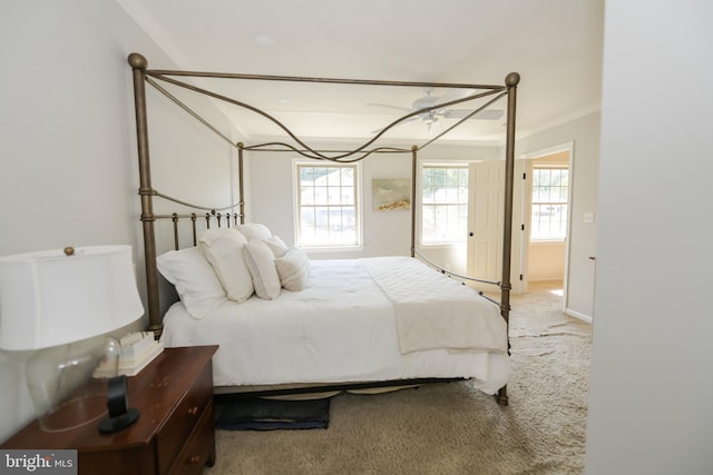 bedroom featuring ceiling fan, ornamental molding, and carpet flooring