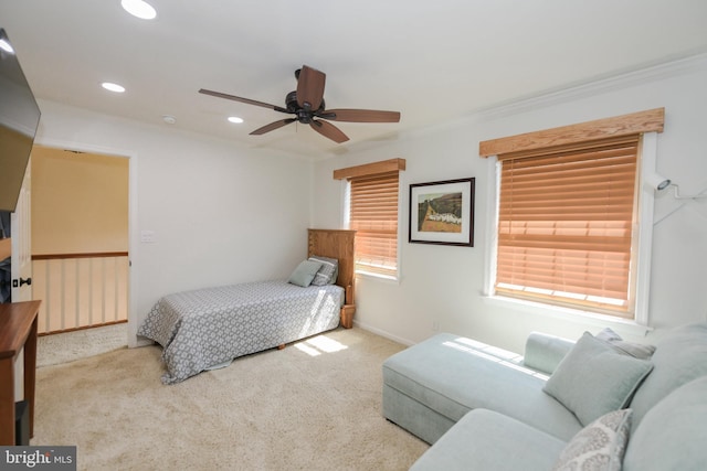 carpeted bedroom with ceiling fan and crown molding