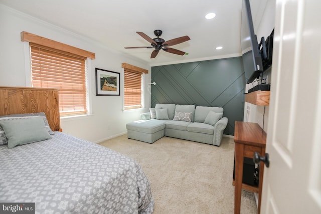 carpeted bedroom with ceiling fan and crown molding