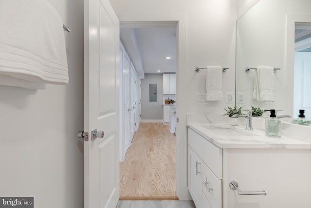 bathroom with vanity, wood-type flooring, and electric panel