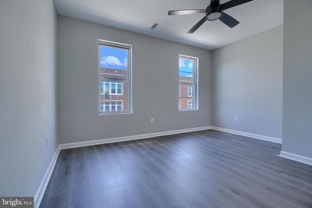 spare room with ceiling fan and dark wood-type flooring