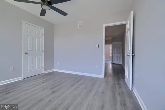 unfurnished room with ceiling fan and light hardwood / wood-style floors