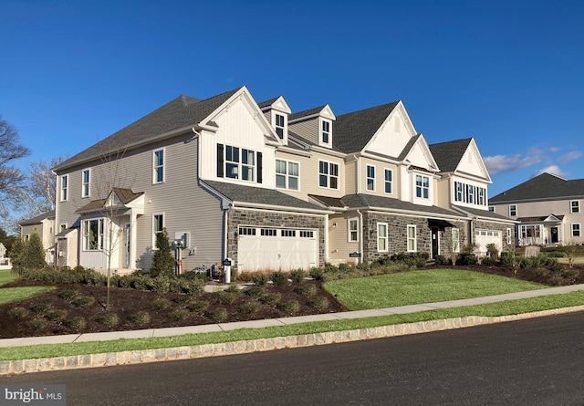 view of front of home featuring a front yard and a garage