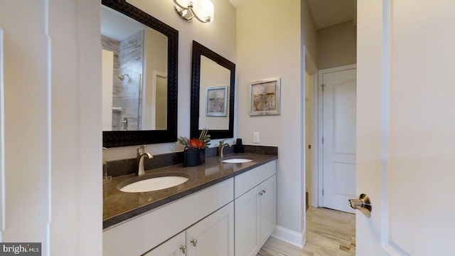 bathroom featuring a shower and vanity