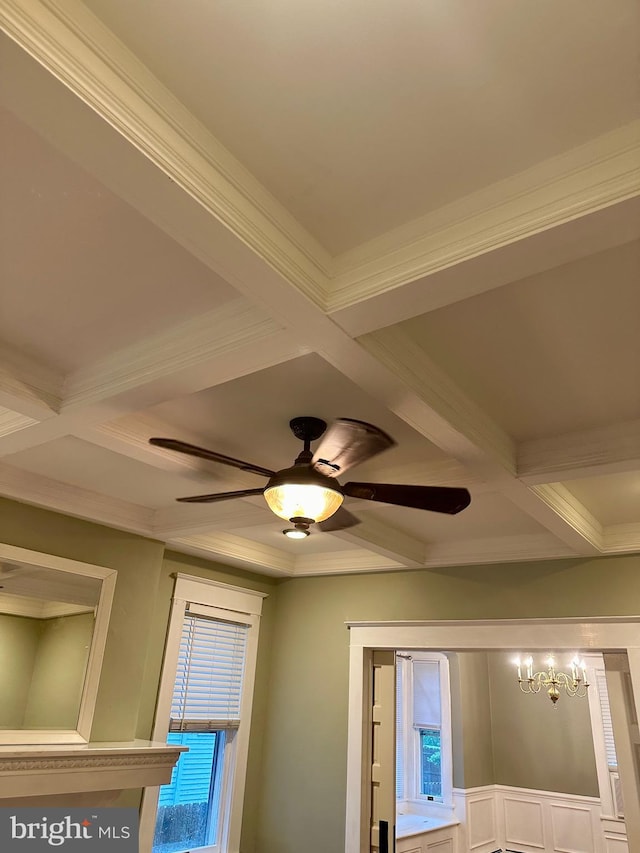 details with ceiling fan with notable chandelier, crown molding, and coffered ceiling