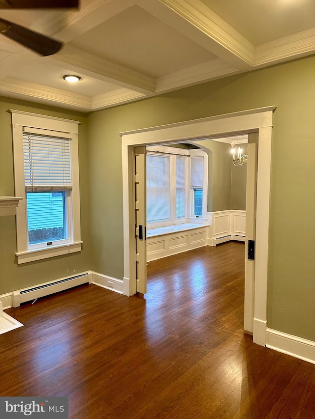 unfurnished room with dark hardwood / wood-style floors, crown molding, and a baseboard heating unit