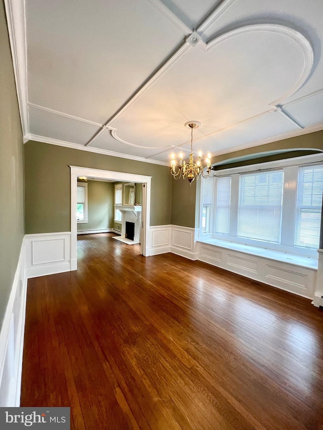 unfurnished living room with a chandelier and dark hardwood / wood-style flooring