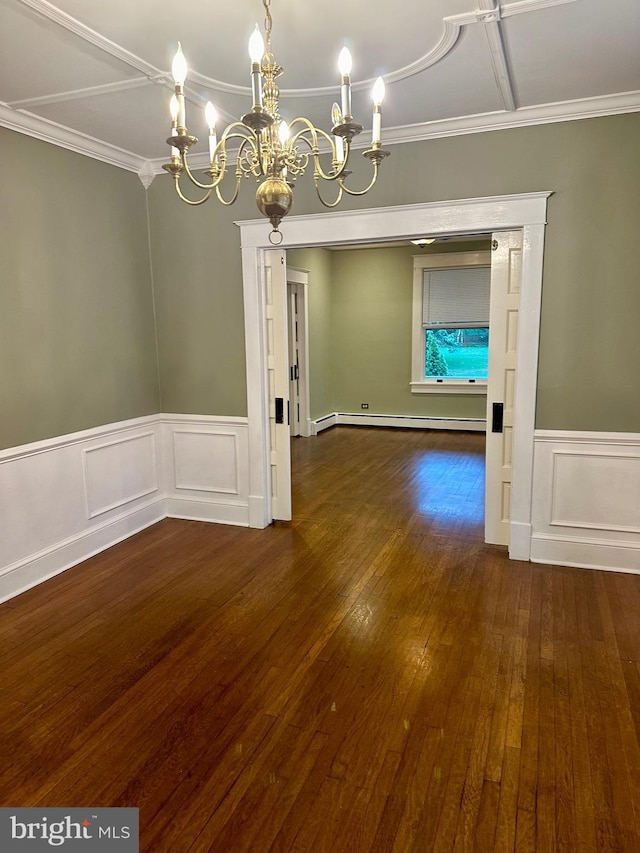 unfurnished dining area featuring dark wood-type flooring, a chandelier, a baseboard heating unit, and ornamental molding