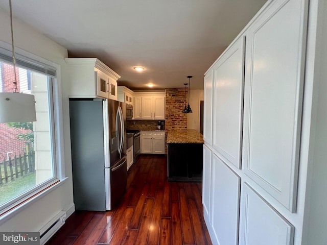 kitchen with light stone countertops, tasteful backsplash, stainless steel appliances, pendant lighting, and white cabinets