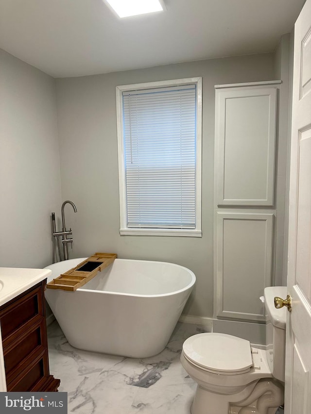 bathroom with vanity, toilet, and a bath