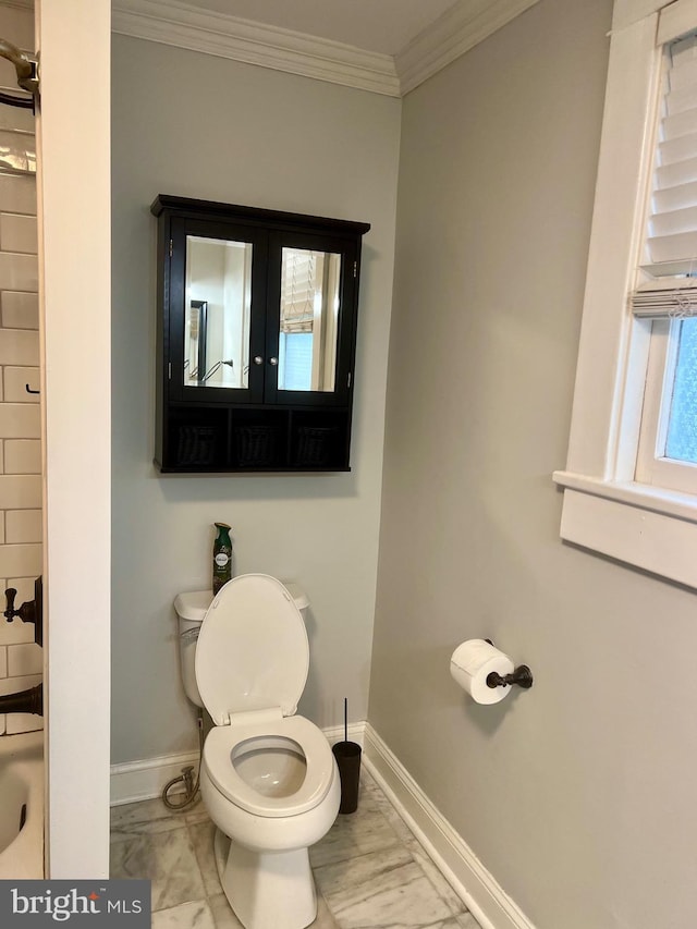 bathroom featuring french doors, toilet, and ornamental molding