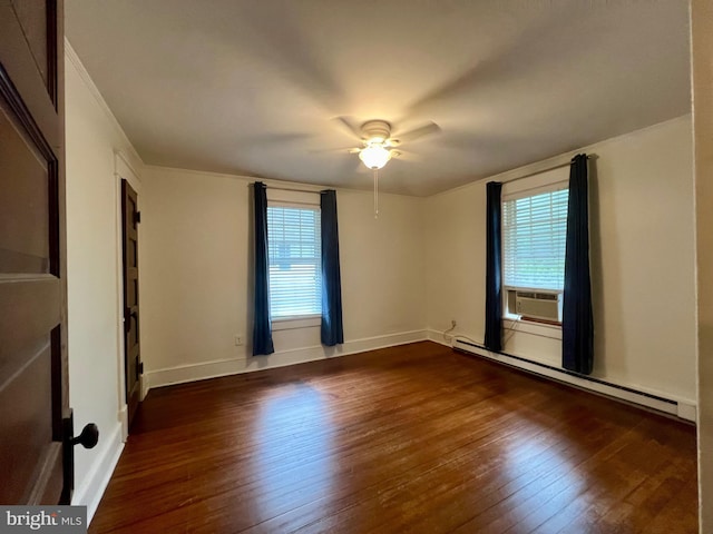 unfurnished room with a wealth of natural light, dark wood-type flooring, ceiling fan, and a baseboard radiator