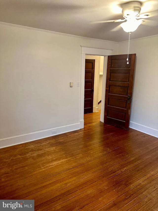 unfurnished room with ceiling fan, dark hardwood / wood-style flooring, and ornamental molding