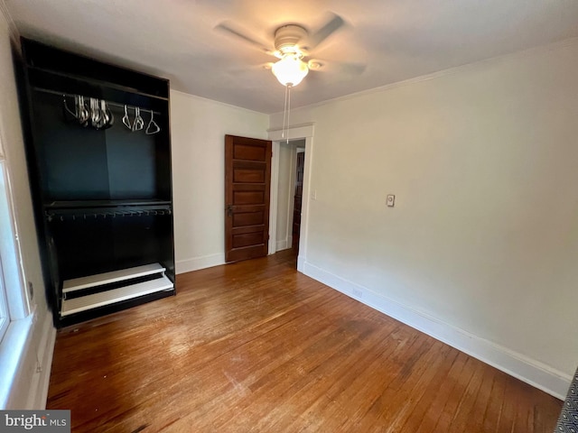 unfurnished room with ceiling fan and hardwood / wood-style flooring