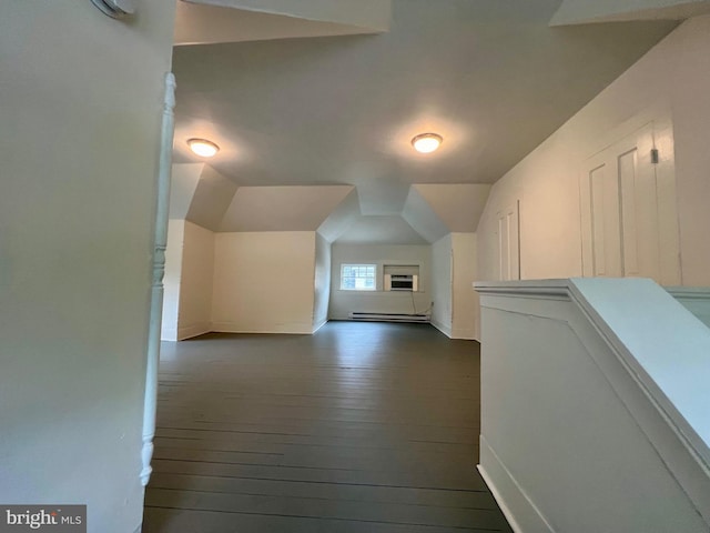 bonus room with dark hardwood / wood-style floors, vaulted ceiling, and a baseboard heating unit