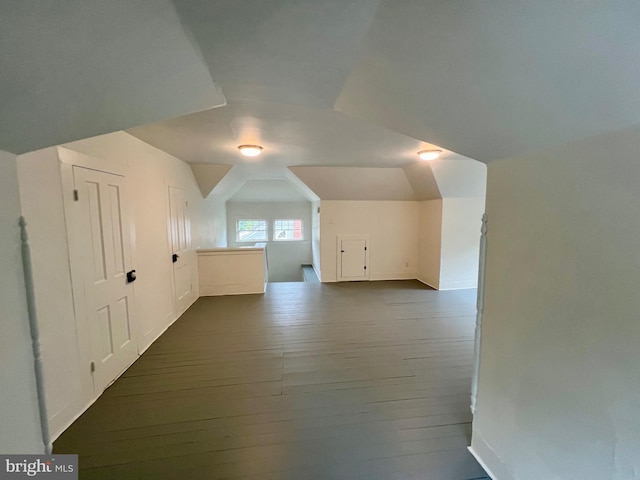 bonus room featuring dark wood-type flooring and lofted ceiling