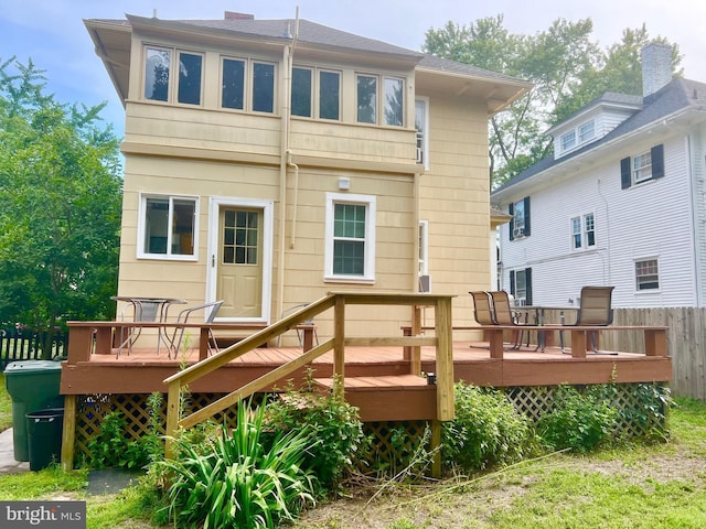 rear view of house with a wooden deck