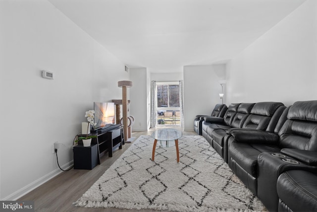 living room featuring wood finished floors and baseboards