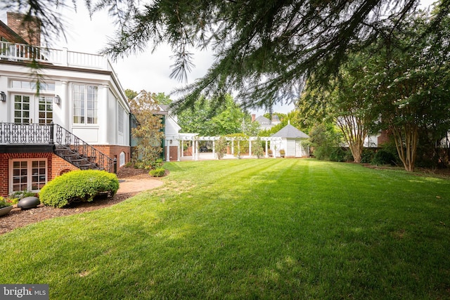 view of yard with a balcony