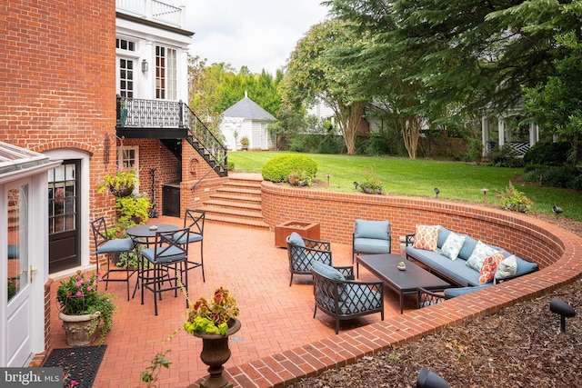 view of patio featuring an outdoor living space and a balcony