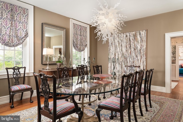 dining space with a chandelier and hardwood / wood-style flooring