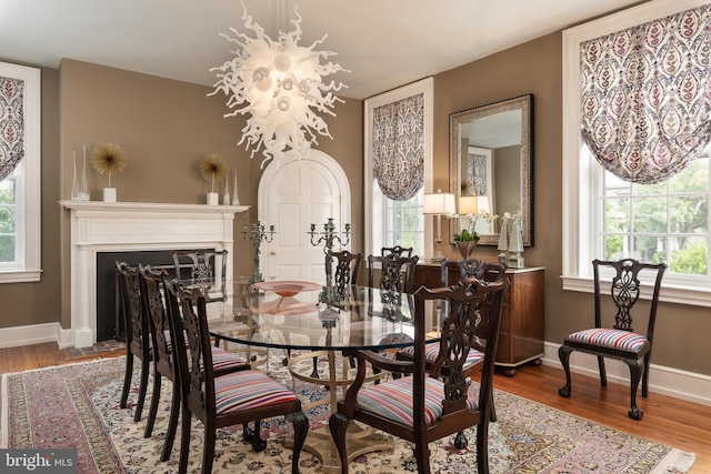 dining room featuring hardwood / wood-style flooring and an inviting chandelier