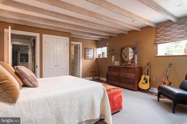 bedroom featuring beam ceiling and carpet floors