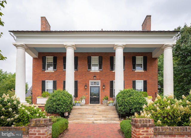 neoclassical home featuring covered porch