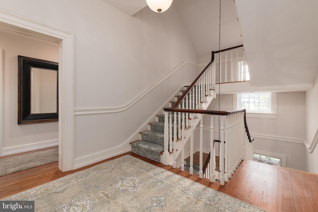 staircase featuring wood-type flooring