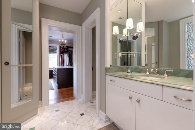 bathroom with vanity and a chandelier