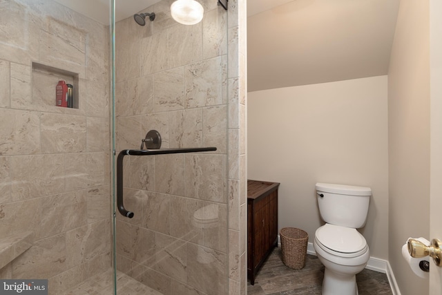 bathroom featuring hardwood / wood-style floors, toilet, and an enclosed shower