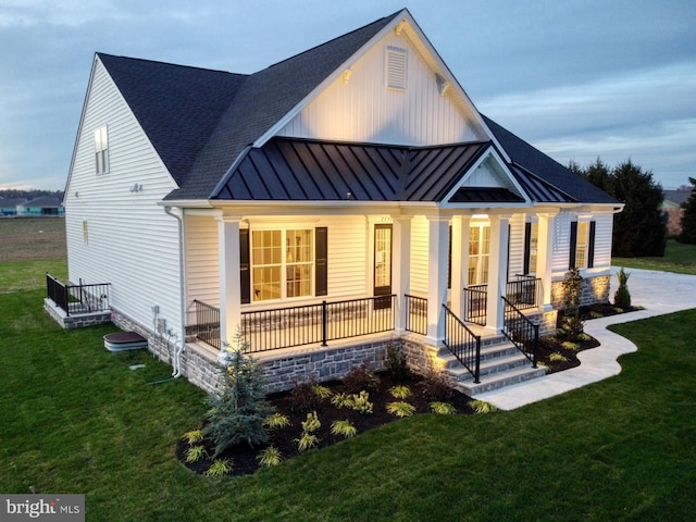 view of front of property with a front yard and a porch