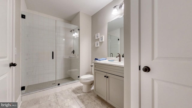 bathroom featuring tile patterned floors, a shower with door, vanity, and toilet