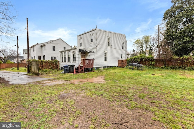 back of house with a lawn