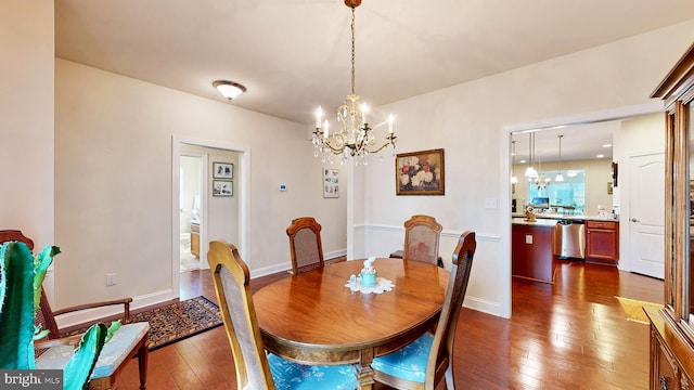 dining room featuring dark hardwood / wood-style floors and an inviting chandelier