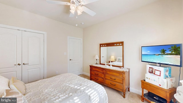 carpeted bedroom featuring ceiling fan and a closet