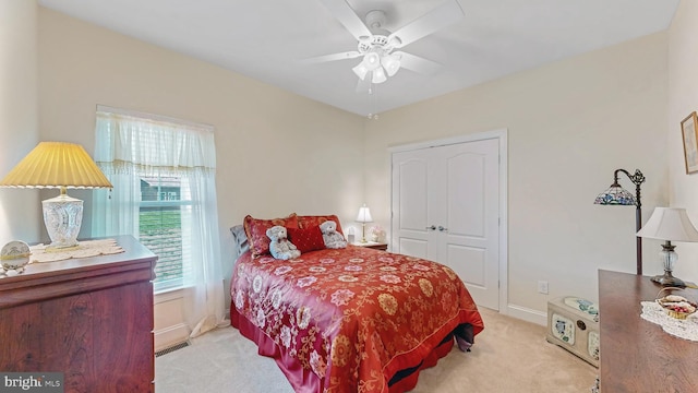 carpeted bedroom with a closet and ceiling fan