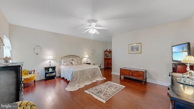 bedroom with dark hardwood / wood-style flooring and ceiling fan