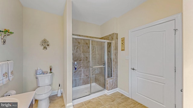 bathroom featuring tile patterned flooring, toilet, and walk in shower