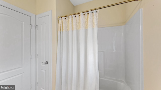 bathroom with shower / bath combination with curtain