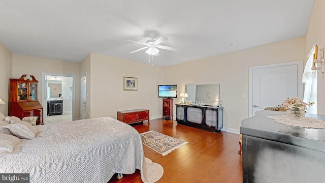 bedroom featuring wood-type flooring, connected bathroom, and ceiling fan