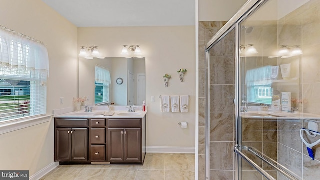 bathroom featuring vanity, tile patterned floors, and a shower with door