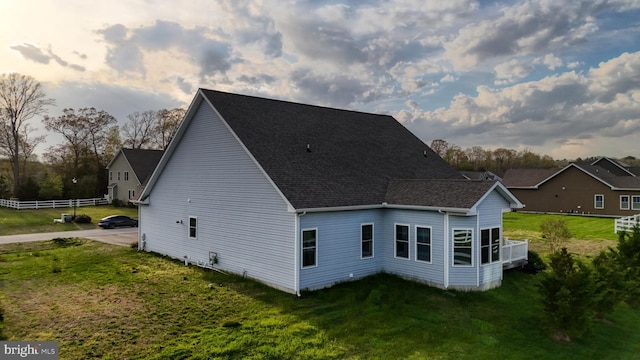 rear view of property featuring a yard