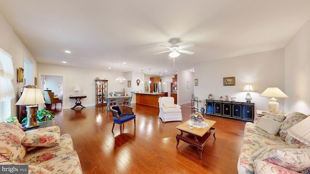 living room featuring ceiling fan and hardwood / wood-style flooring