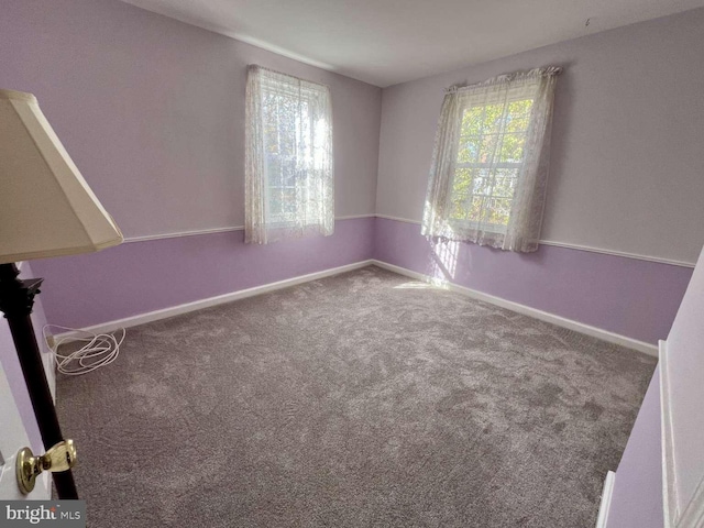 carpeted empty room with plenty of natural light