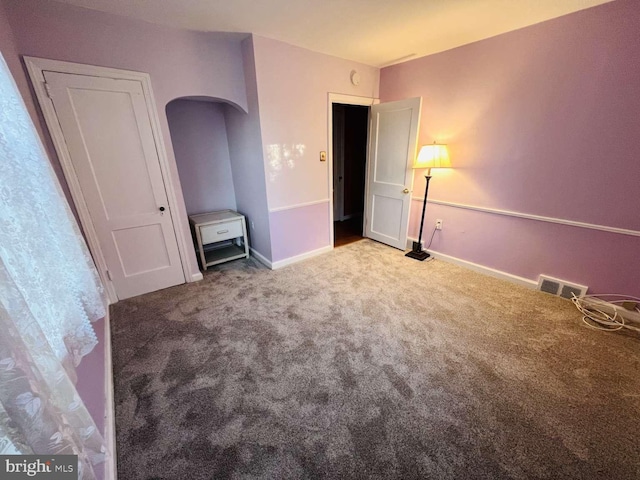 unfurnished bedroom featuring light carpet