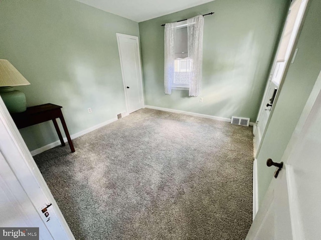 unfurnished bedroom with carpet and multiple windows