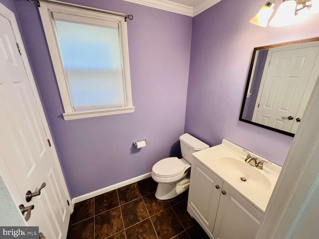 bathroom with tile patterned flooring, toilet, vanity, and ornamental molding