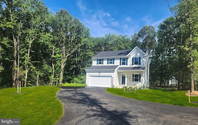 view of front of home featuring a front lawn and a garage